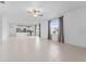 Bright, open-concept living room with tile floors and a view of the kitchen at 11079 Linden Depot Rd, San Antonio, FL 33576