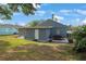 Backyard featuring a patio area with seating and a well-maintained lawn, great for outdoor enjoyment at 11104 Hackney Dr, Riverview, FL 33578