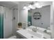 Bathroom featuring white vanity, stylish lighting, and tiled walk-in shower at 11104 Hackney Dr, Riverview, FL 33578