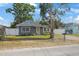 A cozy single-story house featuring a quaint front yard and a white picket fence at 11104 Hackney Dr, Riverview, FL 33578