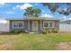Charming single-story home with a well-maintained lawn and front porch at 11104 Hackney Dr, Riverview, FL 33578