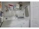 Functional laundry room with washer, dryer, overhead shelving, and ironing board at 11104 Hackney Dr, Riverview, FL 33578