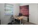 Bright office space with an adjustable standing desk, complemented by a decorative brick-like wall and a window at 11104 Hackney Dr, Riverview, FL 33578