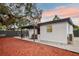 Outdoor living area features a covered patio with an outdoor kitchen and ample seating, ideal for entertaining at 11747 104Th N St, Largo, FL 33773