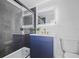 Modern bathroom showcasing sleek gray tiles in the shower, a floating blue vanity, and an LED illuminated mirror at 11747 104Th N St, Largo, FL 33773