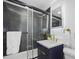 Stylish bathroom featuring a sleek vanity, frameless shower, and illuminated mirror at 11747 104Th N St, Largo, FL 33773