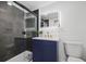 Modern bathroom featuring a navy vanity with a white countertop and a frameless glass shower at 11747 104Th N St, Largo, FL 33773