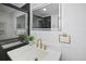 Bathroom vanity featuring modern brass hardware, a smart mirror, and white countertop at 11747 104Th N St, Largo, FL 33773
