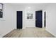 Bedroom with modern light-colored floors, white walls, and contrasting blue doors and trim at 11747 104Th N St, Largo, FL 33773