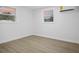 Bright bedroom features wood-look floors, two windows, and a modern mini-split AC unit at 11747 104Th N St, Largo, FL 33773