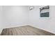 Bright bedroom features wood-look floors, one window, and a modern mini-split AC unit at 11747 104Th N St, Largo, FL 33773