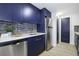 Kitchen featuring stainless steel appliances, modern countertops, and blue cabinets at 11747 104Th N St, Largo, FL 33773
