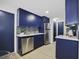 Well-appointed kitchen with stainless steel appliances and sleek blue cabinets at 11747 104Th N St, Largo, FL 33773