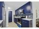 Charming kitchen features stainless steel appliances, subway tile backsplash and custom blue cabinetry at 11747 104Th N St, Largo, FL 33773