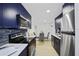 Modern kitchen features stainless steel appliances, subway tile backsplash and custom blue cabinetry at 11747 104Th N St, Largo, FL 33773