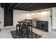Entertain in style with a covered outdoor kitchen featuring a grill, sink, mini-fridge, and seating area at 11747 104Th N St, Largo, FL 33773