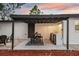 Entertain in style with a covered outdoor kitchen featuring a grill, sink, mini-fridge, and seating area at 11747 104Th N St, Largo, FL 33773