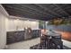 Covered outdoor kitchen with stone accents, stainless grill, mini fridge, sink, and outdoor dining space at 11747 104Th N St, Largo, FL 33773