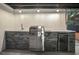 Stainless steel outdoor kitchen complete with a sink, built-in grill, and a mini-refrigerator for ultimate convenience at 11747 104Th N St, Largo, FL 33773