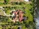 Stunning aerial view of the expansive estate, landscaping, water features, and lake frontage at 11865 Fort King Hwy, Thonotosassa, FL 33592