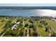 Aerial view of property showcasing the estate, landscaping, and water views at 11865 Fort King Hwy, Thonotosassa, FL 33592