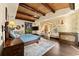 The main bedroom features beamed ceilings, a fireplace, and access to a private balcony at 11865 Fort King Hwy, Thonotosassa, FL 33592