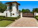 Elegant gated entrance to estate, featuring a guardhouse and brick paved driveway at 11865 Fort King Hwy, Thonotosassa, FL 33592