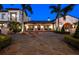 Elegant estate with beautiful landscaping, a fountain, and a grand entrance at twilight at 11865 Fort King Hwy, Thonotosassa, FL 33592