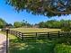 Expansive property features a black fence surrounding the lush green pasture and main home at 11865 Fort King Hwy, Thonotosassa, FL 33592