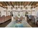 Expansive great room featuring beamed ceilings, columns, and seamless indoor-outdoor living at 11865 Fort King Hwy, Thonotosassa, FL 33592