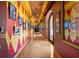 View of the long hallway with star on the floor and various pictures on the patterned walls at 11865 Fort King Hwy, Thonotosassa, FL 33592