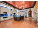 Gourmet kitchen featuring an island with seating, custom cabinetry, and high-end appliances at 11865 Fort King Hwy, Thonotosassa, FL 33592