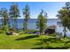 Scenic waterfront property with lush lawn, dock, boathouse, and gazebo at 11865 Fort King Hwy, Thonotosassa, FL 33592