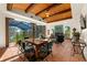 Comfortable living area with fireplace, wood beamed ceiling, clay tile floor, and expansive views of the lake at 11865 Fort King Hwy, Thonotosassa, FL 33592