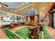 Spacious living room featuring a baseball field rug, comfortable seating, and sports memorabilia at 11865 Fort King Hwy, Thonotosassa, FL 33592