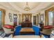 Executive office showcasing custom woodwork, an ornate chandelier, and elegant furnishings for a professional setting at 11865 Fort King Hwy, Thonotosassa, FL 33592