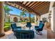 Covered patio with comfortable seating and views of the courtyard and landscaping at 11865 Fort King Hwy, Thonotosassa, FL 33592