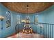 Sweeping staircase with iron railing, enhanced by decorative windows and a distinctive chandelier at 11865 Fort King Hwy, Thonotosassa, FL 33592