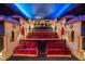 Cozy home theater with plush seating, custom-built structures, and dim lighting for an intimate viewing atmosphere at 11865 Fort King Hwy, Thonotosassa, FL 33592
