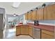 Kitchen with wooden cabinets, modern appliances, and a bright window, creating an inviting space at 12017 Vermillion Way, Riverview, FL 33569
