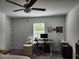 Bedroom featuring a ceiling fan, a window for natural light, and a desk area, ideal for a home office at 12537 Timber Moss Ln, Riverview, FL 33579