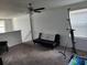 Spacious bonus room featuring cozy seating, a ceiling fan, and natural light at 12537 Timber Moss Ln, Riverview, FL 33579