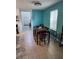 Inviting dining room features a modern ceiling fan, tile floors, and a teal accent wall, perfect for Gathering meals at 12537 Timber Moss Ln, Riverview, FL 33579