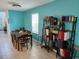 Bright dining room with blue walls, tile flooring, and a modern dining set at 12537 Timber Moss Ln, Riverview, FL 33579