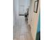 The entryway has light tile floors, a console table, and a view of the front door at 12537 Timber Moss Ln, Riverview, FL 33579