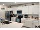 Modern kitchen with white cabinets, stainless steel appliances, and quartz countertops at 12537 Timber Moss Ln, Riverview, FL 33579