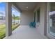 Relaxing back porch with comfortable seating and a view of the lush backyard at 1432 Gopher Loop, Tarpon Springs, FL 34689