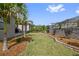 Well-maintained backyard featuring lush green lawn, mature landscaping, and privacy fencing at 1432 Gopher Loop, Tarpon Springs, FL 34689