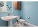 Stylish powder room featuring a pedestal sink and patterned tile flooring at 1432 Gopher Loop, Tarpon Springs, FL 34689