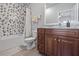Elegant bathroom featuring a shower-tub combination with stylish tile and a vanity with wood cabinets at 1432 Gopher Loop, Tarpon Springs, FL 34689